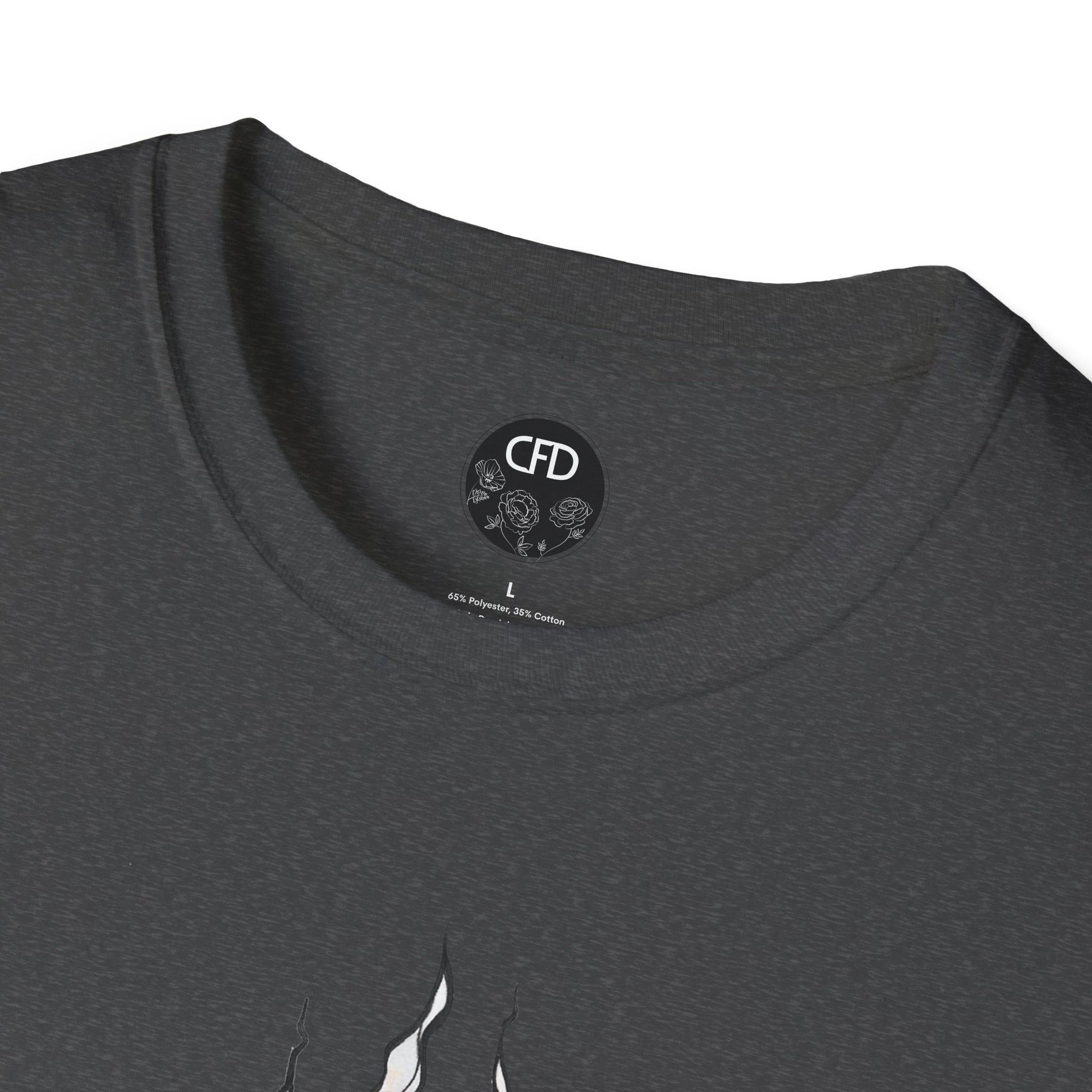 This is the Dark Heather English Breakfast Tea T-Shirt by Chris Foster Design. It comes in sizes XS-5XL. This is a close up of the front with a circular CFD logo in white lettering and black background. The CFD logo and white flowers surrounding the bottom of the lettering. The size label is below the logo in black. From the closeup a little bit of the illustration is white wisps. The image is against a white background.