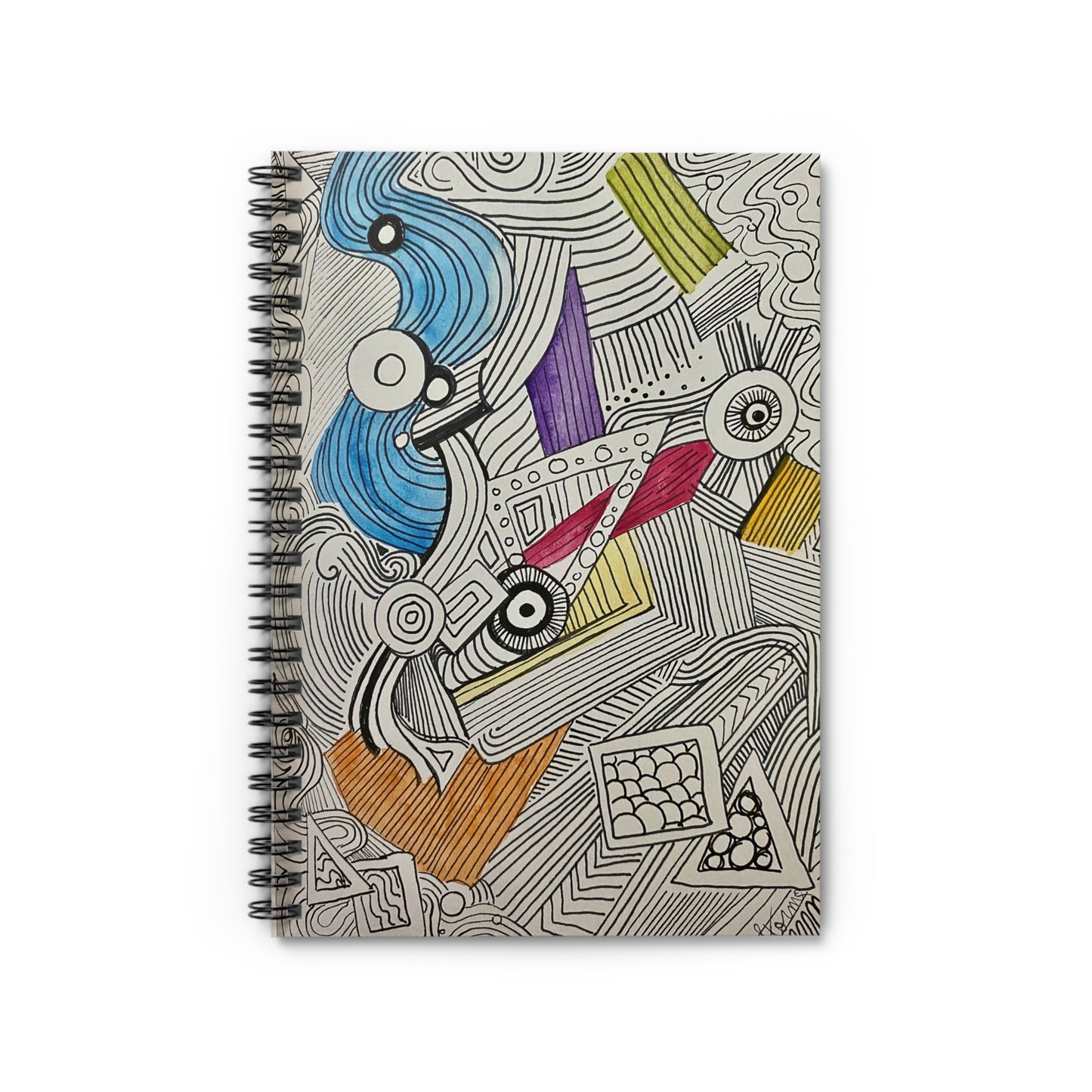 This is the Doodle Spiral Notebook with Ruled Line Paper and metal spiral binding by Storm Garden Studio. This is an image of the notebook from the front at eagles' view. The illustration is different shapes, lines and colors going in all directions. Most of it is black and white with sparse colors. There is blue, yellow, purple, red and orange. It is on a white surface. 