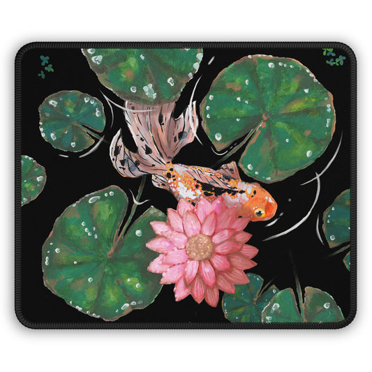 This is the Goldfish Mouse Pad by Chris Foster Design. This shows the front corner where the threading begins. The illustration has the background in black, nine dark or light green lily pads, small foliage, one orange, white and black goldfish and a pink blooming flower. The mouse pad is against a white background.