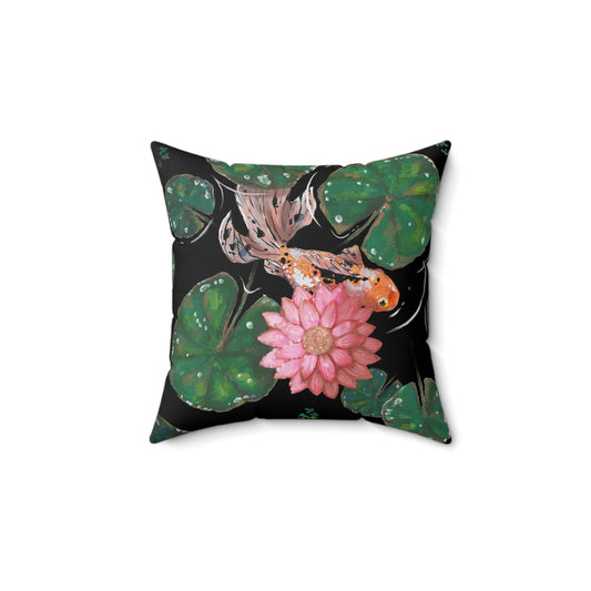 This is the 14" x 14" Goldfish Pillow by Chris Foster Design. This shows the front of the pillow. The illustration has the background in black, nine dark or light green lily pads, small foliage, one orange, white and black goldfish and a pink blooming flower. The print is on both sides of the pillow. The pillow is against a white background.