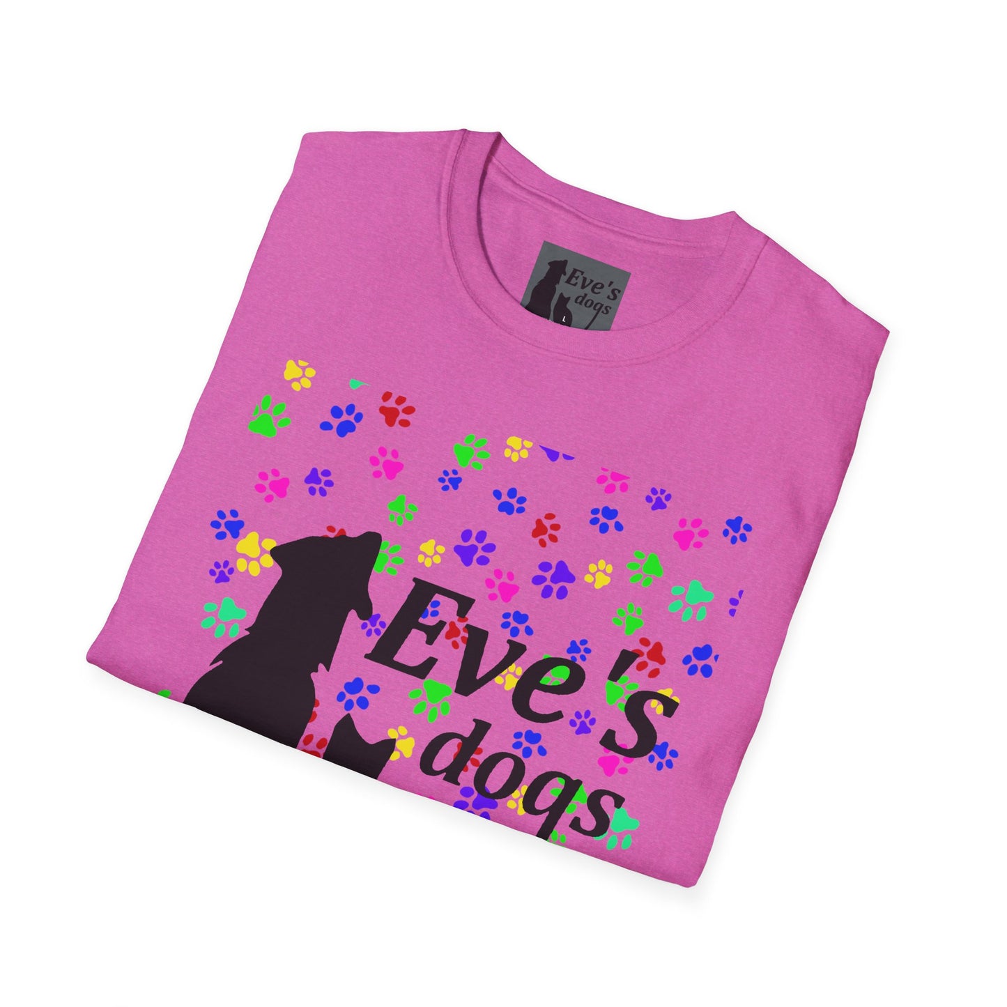 This is the Heather Berry Adopt Eve's Dogs T-Shirt. It comes in XS - 5XL. The image is the shirt folded and showing the front. The size label is a grey and black tag with a dog and cat with the "Eve's dogs" writing. The front has pink, green, blue, purple, red paw prints in different sizes. Also, the dog and cat with "Eve's dogs" printed in black. It is against a white background.