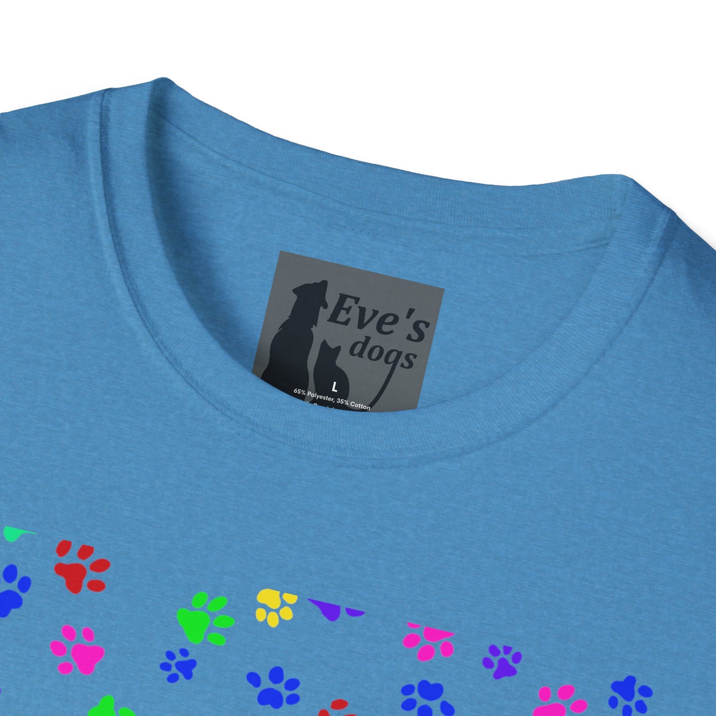 This is the Heather Sapphire Adopt Eve's Dogs T-Shirt. It comes in XS - 5XL. This is an upclose image of the shirt where the neck/tag is. The size label is a grey and black tag with a dog and cat with the "Eve's dogs" writing. The sizes and shirt product materials are printed in white. There is a little bit of paw prints on the front.  The colors are pink, green, blue, purple, red paw prints in different sizes. It is against a white background.