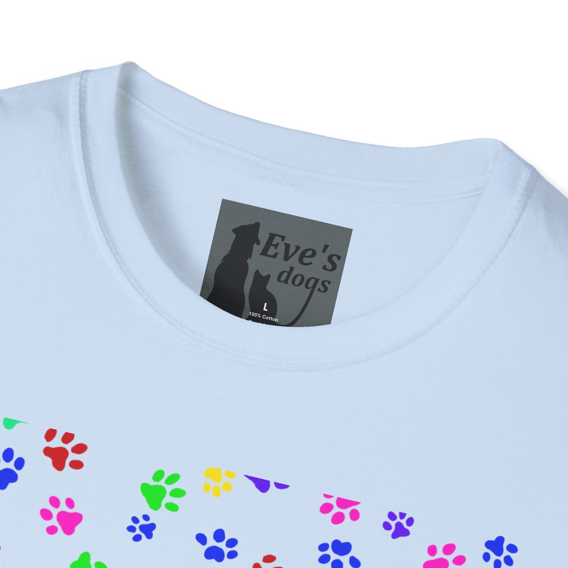 This is the Light Blue Adopt Eve's Dogs T-Shirt. It comes in XS - 5XL. This is an upclose image of the shirt where the neck/tag is. The size label is a grey and black tag with a dog and cat with the "Eve's dogs" writing. The sizes and shirt product materials are printed in white. There is a little bit of paw prints on the front.  The colors are pink, green, blue, purple, red paw prints in different sizes. It is against a white background.