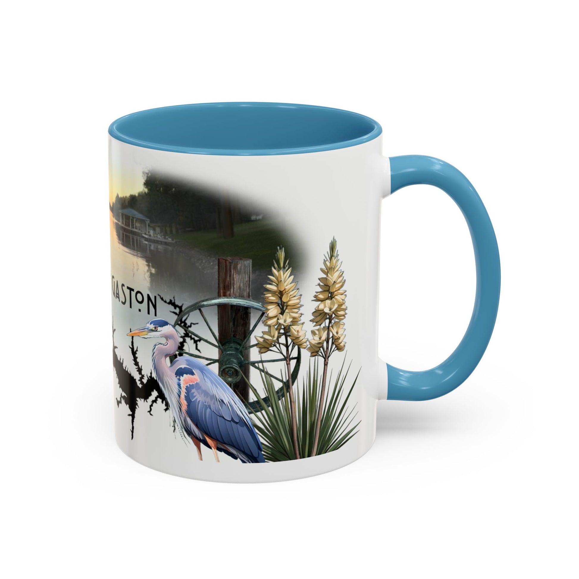 This is the 11oz Light Blue Lake Gaston Mug. It is an illustration by Lee Hansheng Studios. The picture is shown from the right side of the mug. The handle and inside of mug are color matched too. The mug is all white except for the illustration and handle. The illustration shows two yucca plants on the right, a great blue heron and a green wheel that is attached to a log. The mug is against a white background in the picture too.