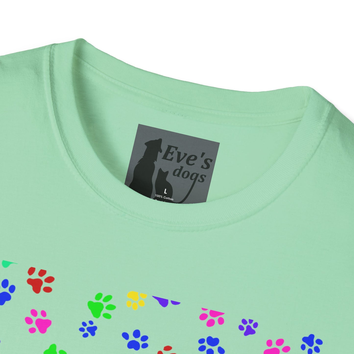 This is the Mint Green Adopt Eve's Dogs T-Shirt. It comes in XS - 5XL. This is an upclose image of the shirt where the neck/tag is. The size label is a grey and black tag with a dog and cat with the "Eve's dogs" writing. The sizes and shirt product materials are printed in white. There is a little bit of paw prints on the front.  The colors are pink, green, blue, purple, red paw prints in different sizes. It is against a white background.