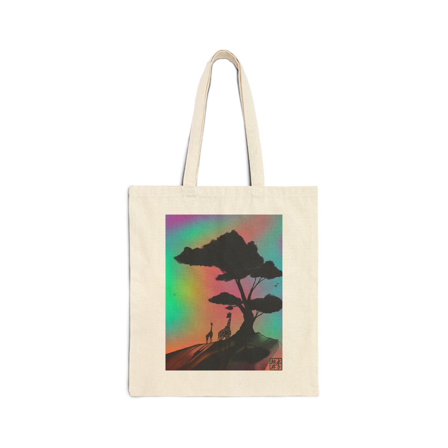 This is the Natural 15" x 16" A Glance Tote Bag design by Lee Hansheng Studios. The handles are color matched. It is a sillhouette illustration in the middle of the shirt of a large tree rooted in the land. It is an orange red color with shadows reflected on it. One giraffe is in the foreground whereas the other is near the background spotted in black. The background is a mirage of pink, blue, yellow and red.