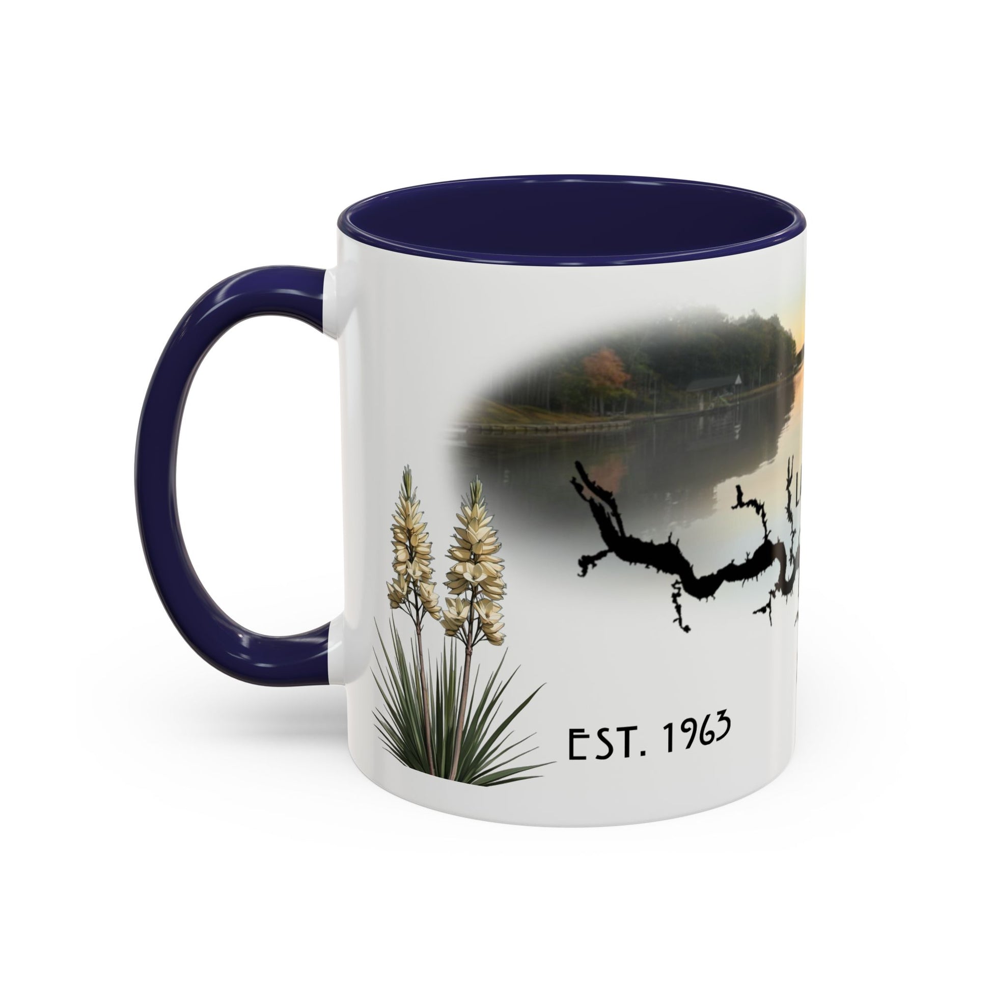 This is the 11oz Navy Lake Gaston Mug. It is an illustration by Lee Hansheng Studios. The picture is shown from the left side of the mug. The handle and inside of mug are color matched too. The mug is all white except for the illustration and handle. The illustration shows some yucca plants on the left, serene depiction of the lake in the back, the shadow of a tree and "EST.1963". The mug is against a white background in the picture too.