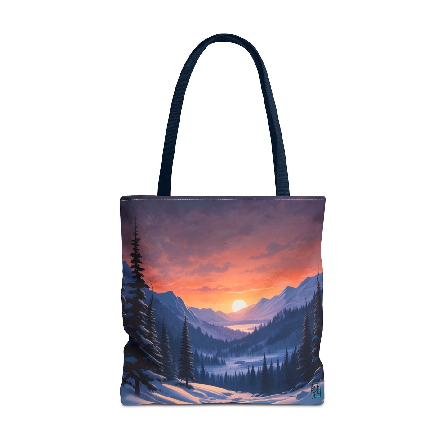 The Navy 18" x 18" Snow Valley Tote Bag has color matched handles and all around print. The tote is against a white background.The design by Lee Hansheng Studios showcases a snowy hill/mountain area with large pine trees on both sides continuing into the horizon. The sun rises past the horizon consisting of yellow,orange,red hues illuminating onto wispy clouds,snowy field, mountains and dark green pine trees. 