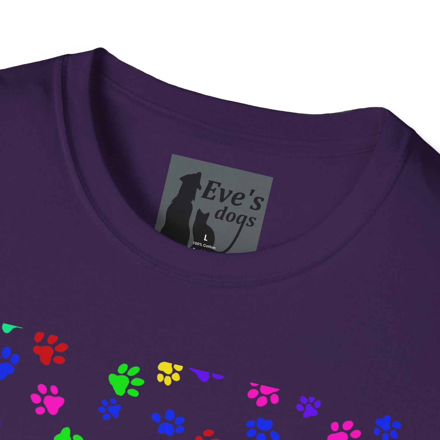 This is the Purple Adopt Eve's Dogs T-Shirt. It comes in XS - 5XL. This is an upclose image of the shirt where the neck/tag is. The size label is a grey and black tag with a dog and cat with the "Eve's dogs" writing. The sizes and shirt product materials are printed in white. There is a little bit of paw prints on the front.  The colors are pink, green, blue, purple, red paw prints in different sizes. It is against a white background.