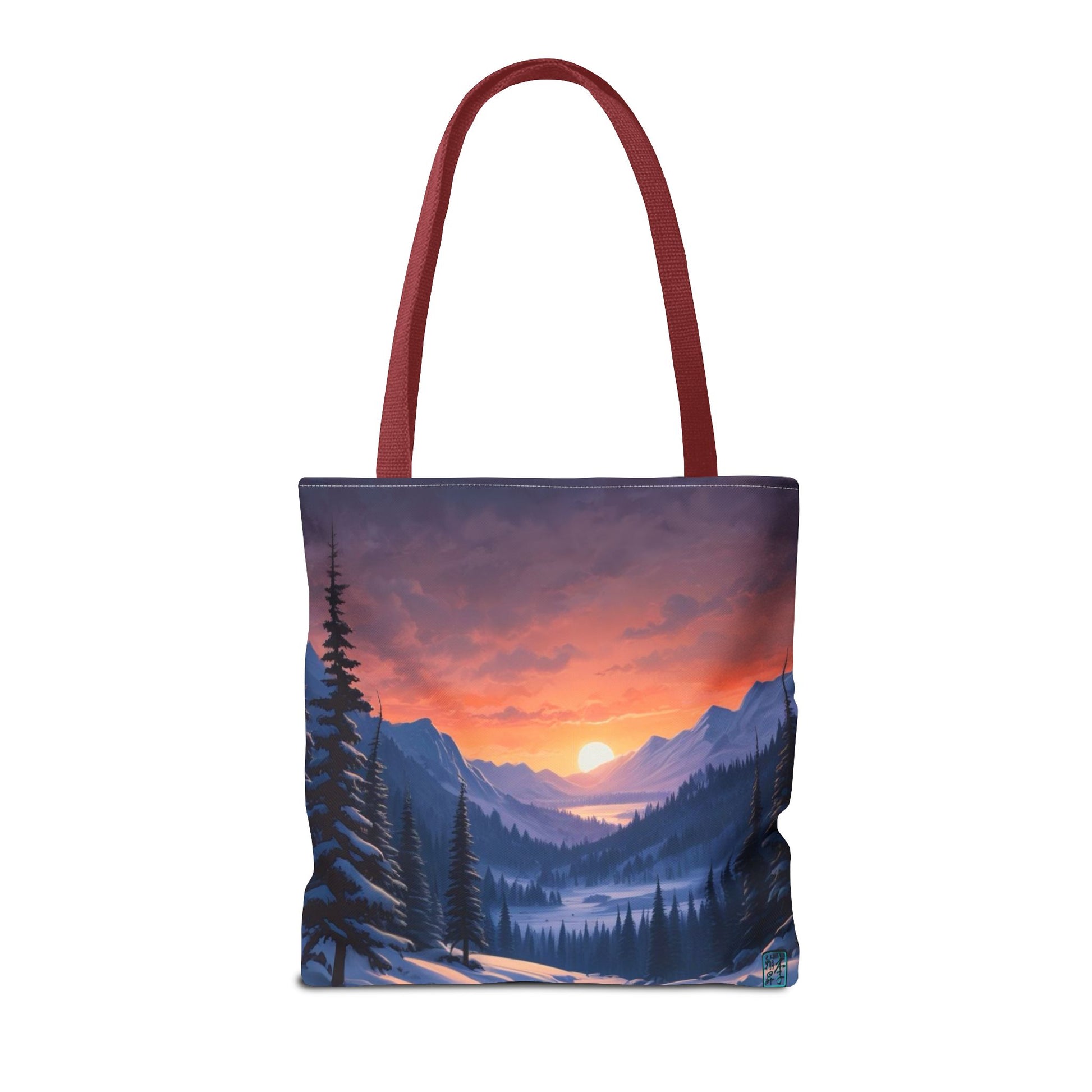 The Red 16" x 16" Snow Valley Tote Bag has color matched handles and all around print. The tote is against a white background.The design by Lee Hansheng Studios showcases a snowy hill/mountain area with large pine trees on both sides continuing into the horizon. The sun rises past the horizon consisting of yellow,orange,red hues illuminating onto wispy clouds,snowy field, mountains and dark green pine trees. 