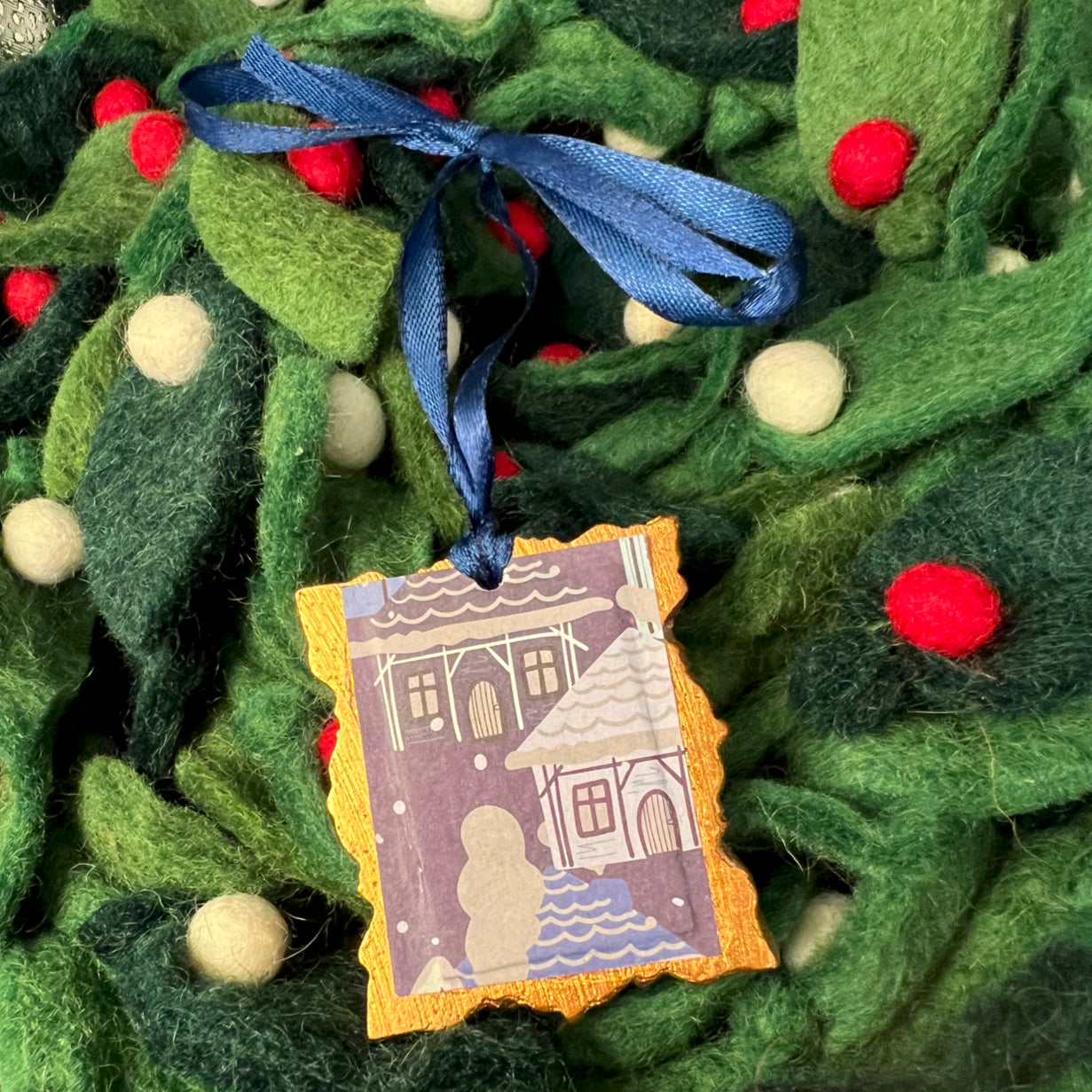 Close-up of the Star of Bethlehem ornament's textured gold glitter surface and intricate star shape, highlighting fine