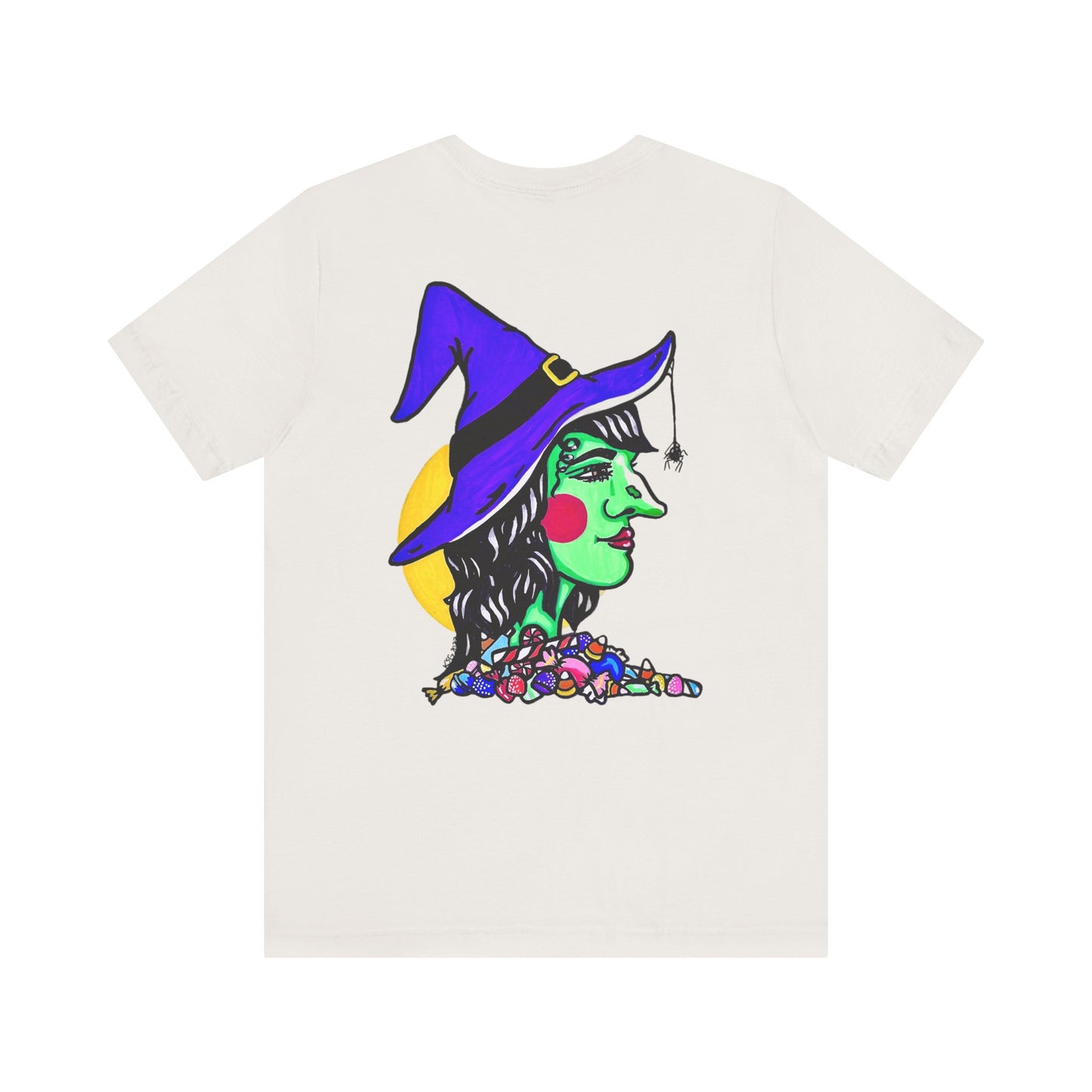 This is the Vintage White Trick or Treat! Witch T-Shirt by Storm Garden Studio. This is the back of the shirt. It shows the side profile image of a witch. She is facing the right side. She has a purple witch hat with a black belt, yellow buckle, a spider crawling down the front, red rosy cheeks, red lips and assorted candy under the neck. Behind her is a bright yellow circle past her hair. 
