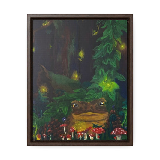 This is the Walnut frame 11" x 14" Forest Toad Gallery Canvas Wrap by Storm Garden Studio. The frame depth is 1.25". This is a front image with the frame. It is an illustration deep in the forest with different sizes of red spotted mushrooms, pinecones, vines and a toad. In the background there are fireflies, large ivy vine and a large mossy log. The illustration is framed on a white background.