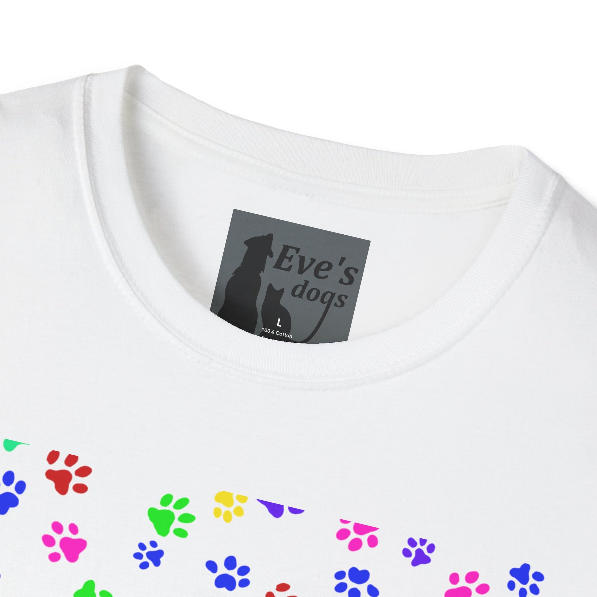 This is the White Adopt Eve's Dogs T-Shirt. It comes in XS - 5XL. This is an upclose image of the shirt where the neck/tag is. The size label is a grey and black tag with a dog and cat with the "Eve's dogs" writing. The sizes and shirt product materials are printed in white. There is a little bit of paw prints on the front.  The colors are pink, green, blue, purple, red paw prints in different sizes. It is against a white background.