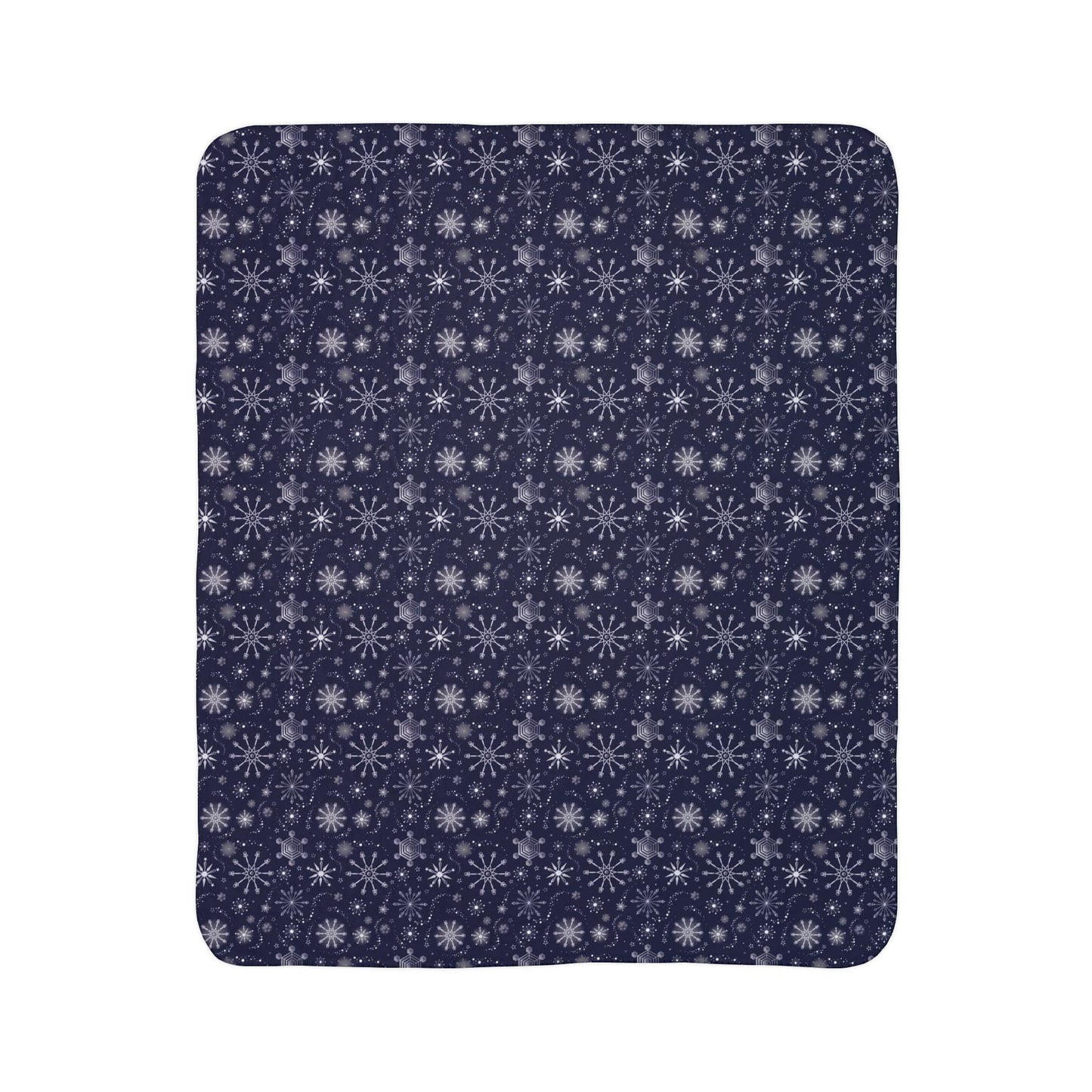 This is the beige 50" x 60" Winter Blizzard Sherpa Blanket shown vertically. The background is white. The design are different types of snowflakes with different sizes of circles within each flake. The blanket is dark blue and the snowflakes and design are all white and spread throughout.