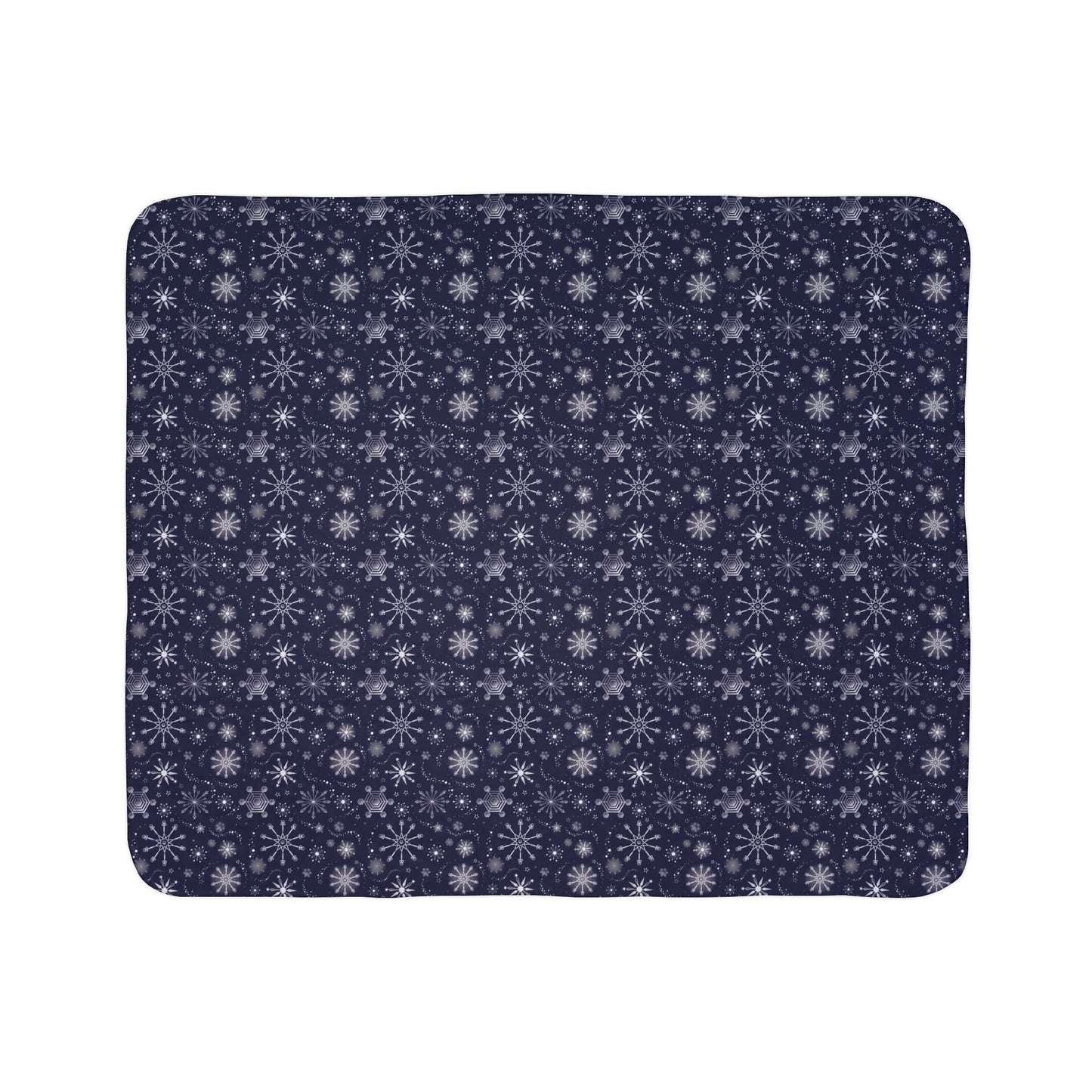 This is the grey 50" x 60" Winter Blizzard Sherpa Blanket shown horizontally. The background is white. The design are different types of snowflakes with different sizes of circles within each flake. The blanket is dark blue and the snowflakes and design are all white and spread throughout.