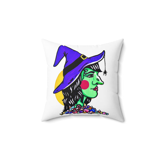 This is the 14" x 14" Witch Spun Polyester Square Pillow. This is the front side of the pillow. It shows the side profile image of a witch. She is facing the right side. She has a purple witch hat with a black belt, yellow buckle, a spider crawling down the front, red rosy cheeks, red lips and assorted candy under the illustration by the neck. Behind her is a bright yellow circle past her hair. The colors of the candy are red, white, orange, blue and purple. It is against a white background.