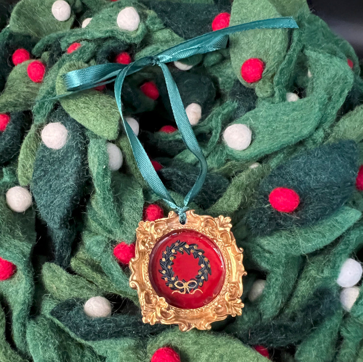 CFD Festive Wreath Green Ornament with textured pine needles, red berry accents, and a jute hanging loop, by The Art