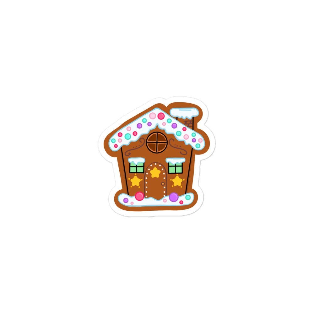 Gingerbread house sticker with brown icing textures, colorful candy accents, and Dazzle & Daggers Design branding from The